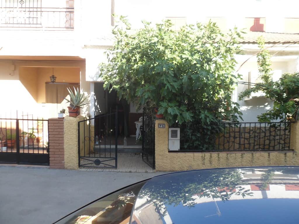 Charming village property in Zujar, Granada, featuring a lush garden and traditional architecture. P.