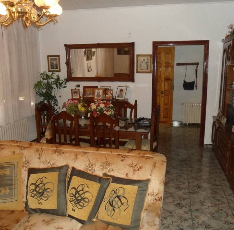 Cozy living room with traditional decor and wooden furniture in a village property in Zujar, Granada.