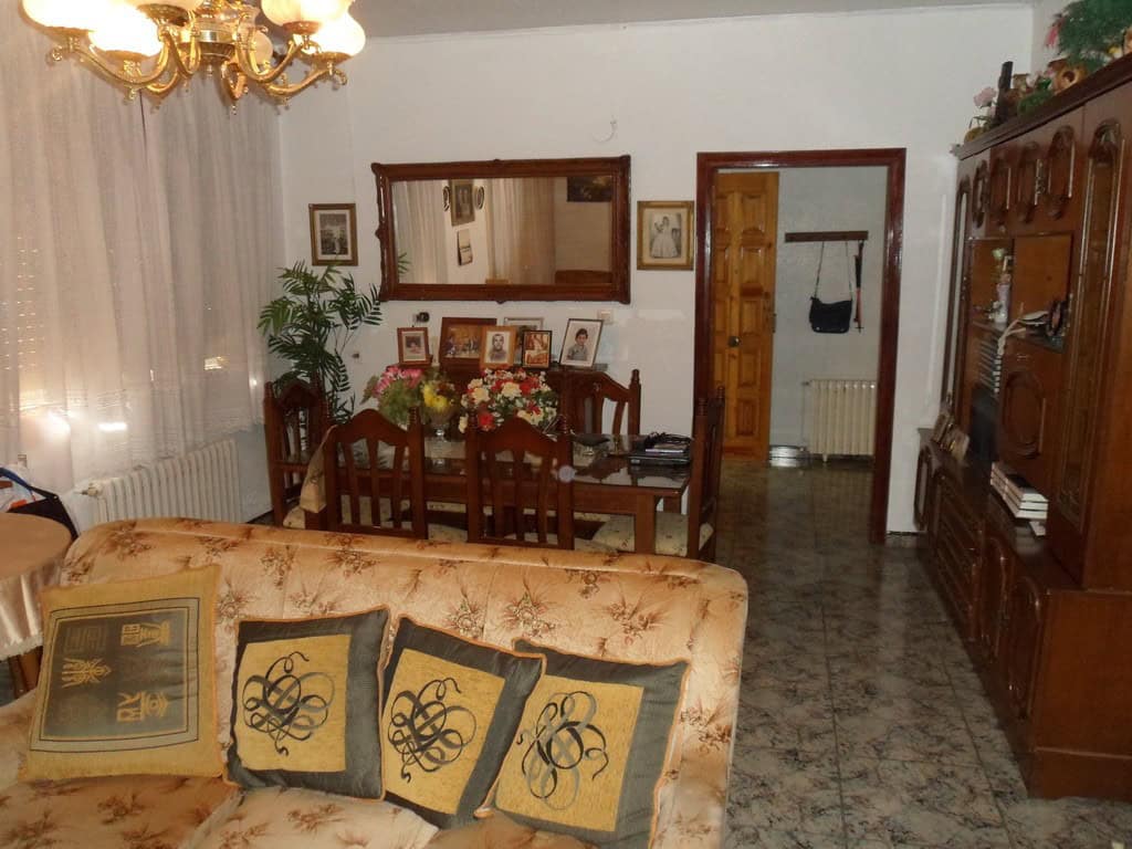 Cozy living room with traditional decor and wooden furniture in a village property in Zujar, Granada.