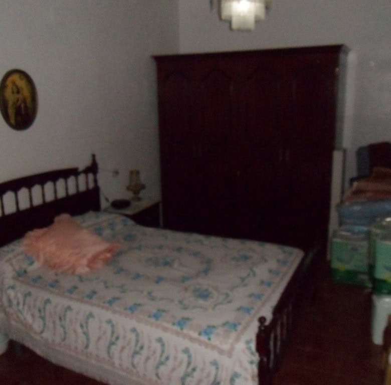 Village property bedroom with traditional furniture in Zujar, Granada.