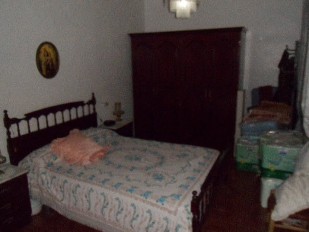Village property bedroom with traditional furniture in Zujar, Granada.