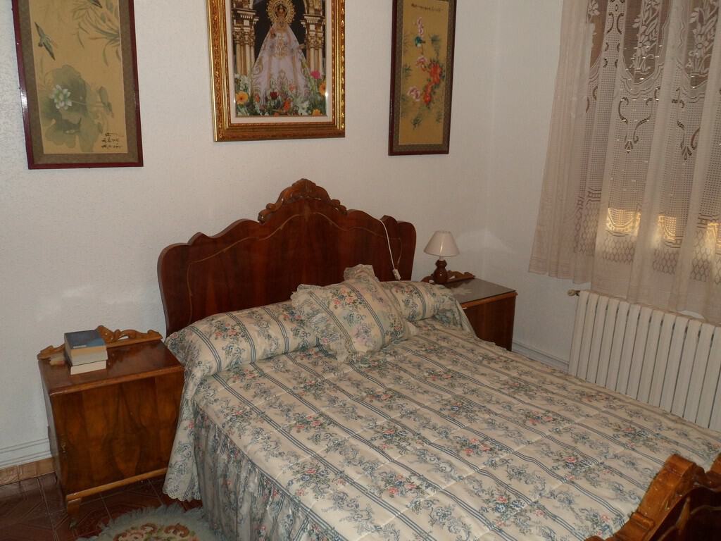 Cozy bedroom in a village property in Zujar, Granada, featuring traditional decor and wooden furnitu.