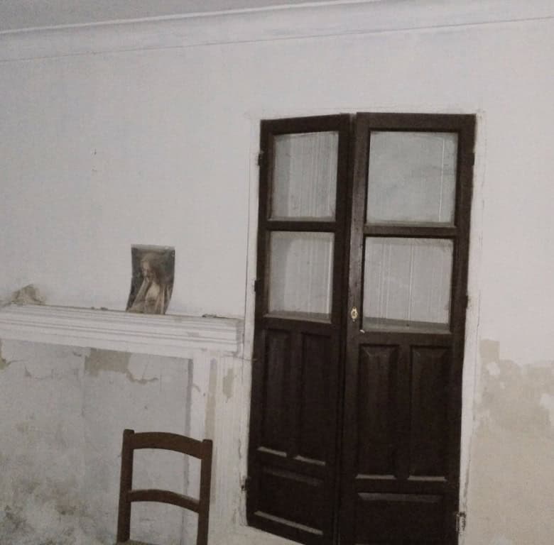 Image of an unfinished rural property interior in La Alqueria, Granada, showing wooden window frames.