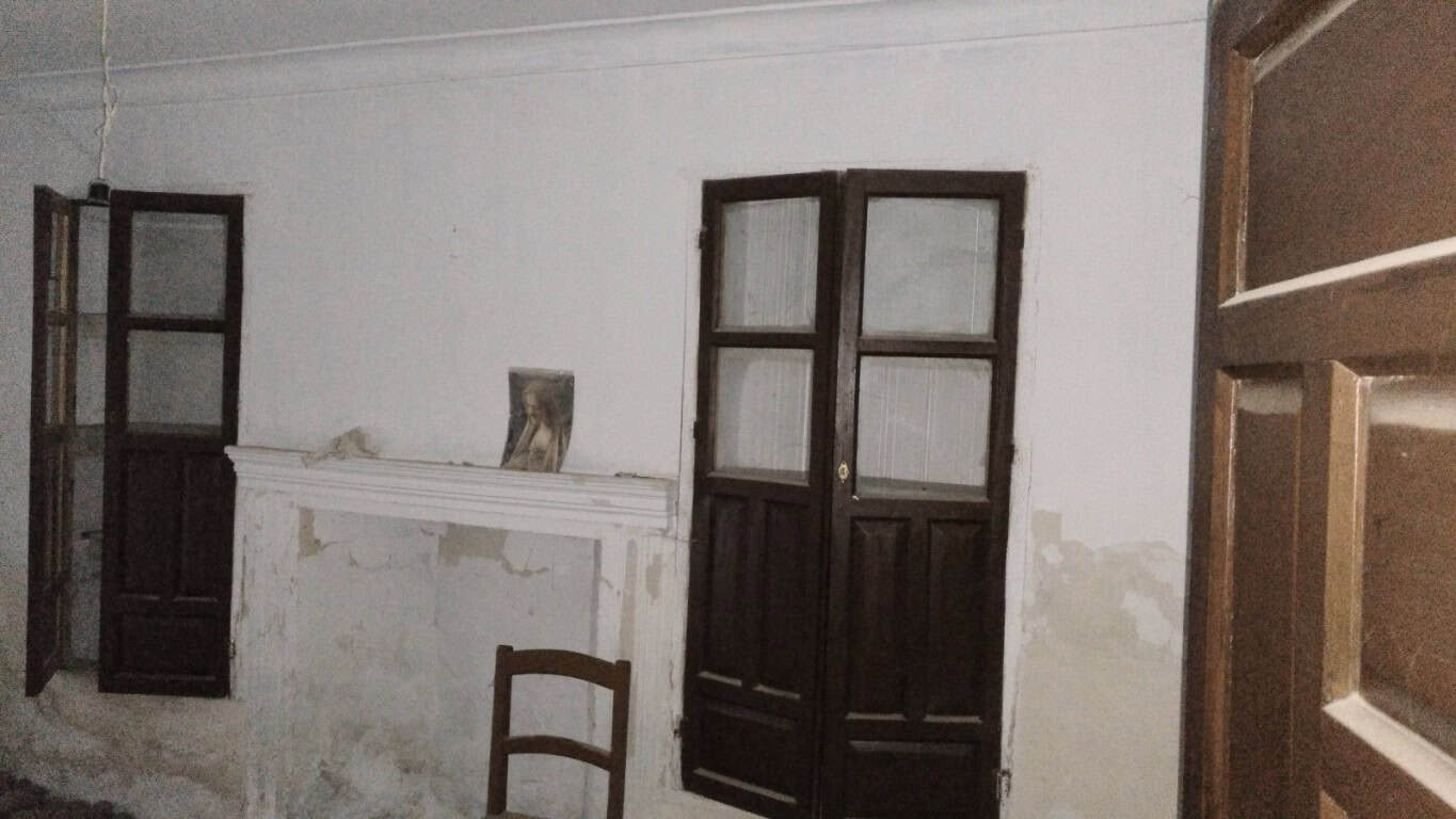 Image of an unfinished rural property interior in La Alqueria, Granada, showing wooden window frames.