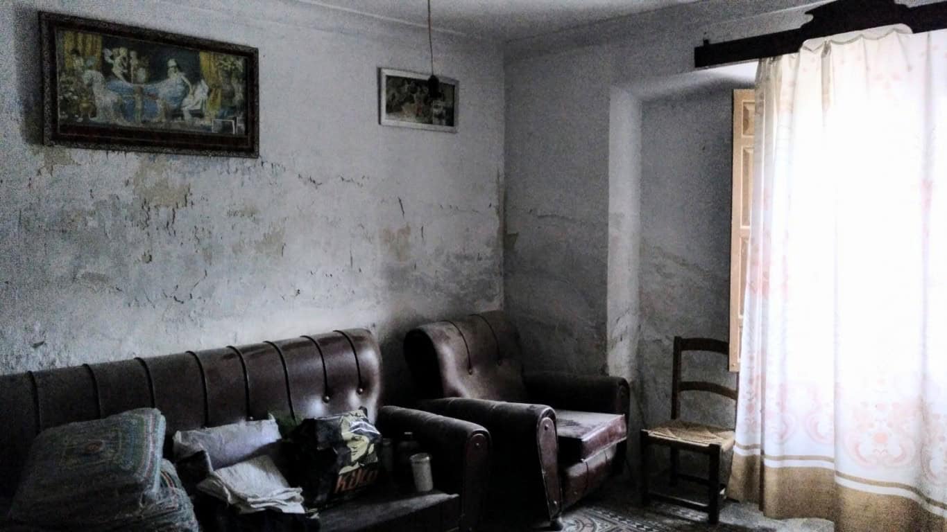 Charming interior of a rural property in La Alqueria, Granada, featuring rustic furniture and tradit.