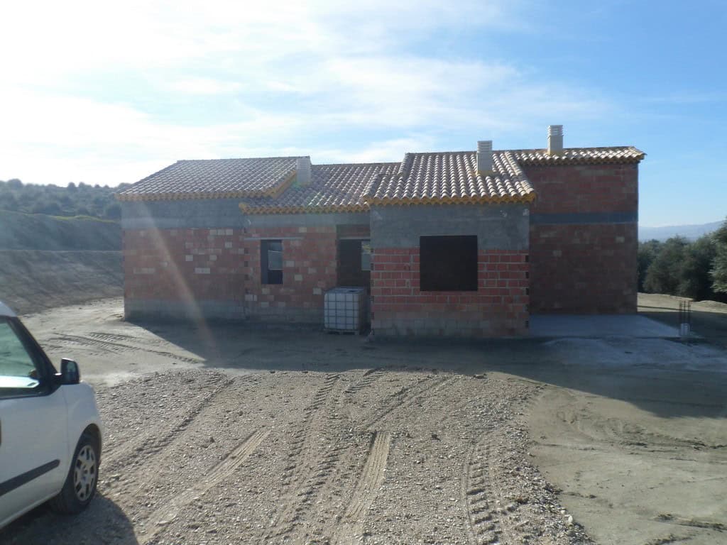 Farm property in Benamaurel, Granada with unfinished walls and rural surroundings.