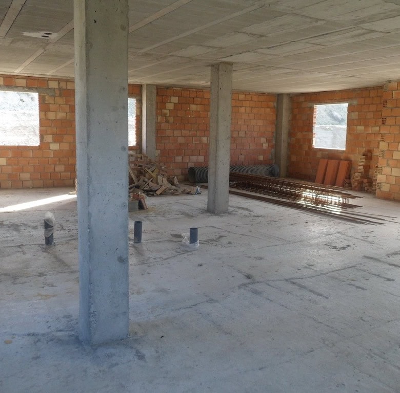 Farm property construction site in Benamaurel, Granada, showing an unfinished building with brick wa.