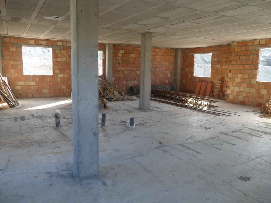 Farm property construction site in Benamaurel, Granada, showing an unfinished building with brick wa.