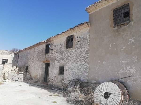 Farm property in Orce, Granada with rustic stone walls and traditional architecture.