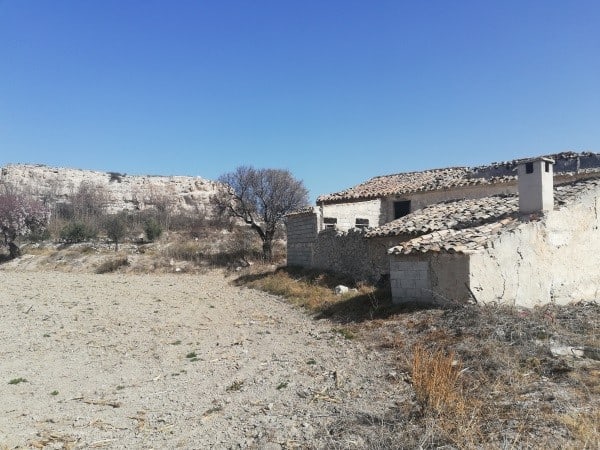 Farm property in Orce, Granada with rustic buildings and scenic landscape.