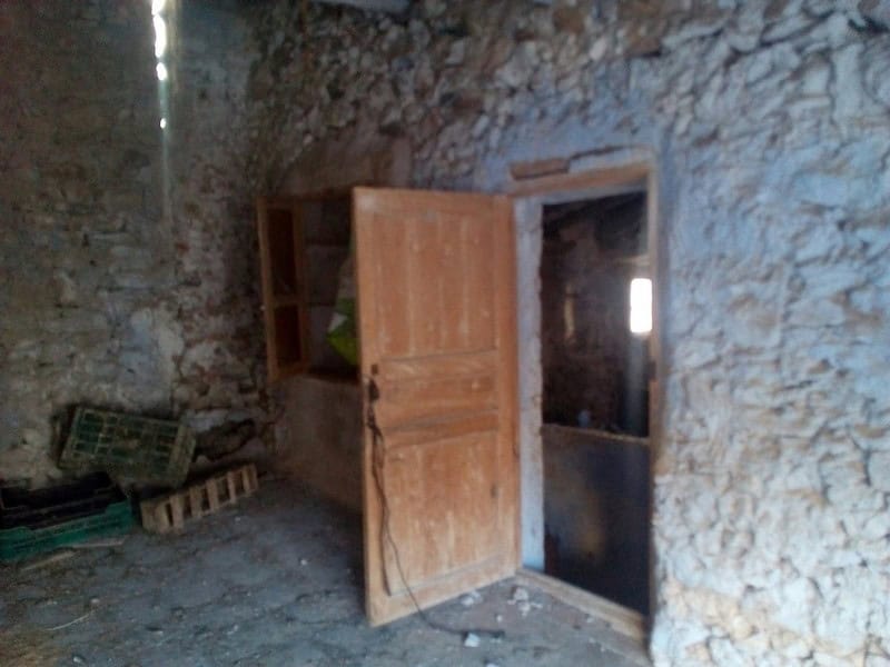 Charming rustic village property in Bayarque, Almeria, with stone walls and wooden door, ideal for r.