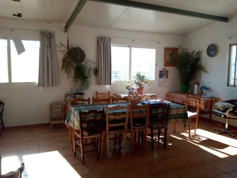 Interior view of a traditional village property in Hijate, Almeria, showcasing a cozy dining area wi.
