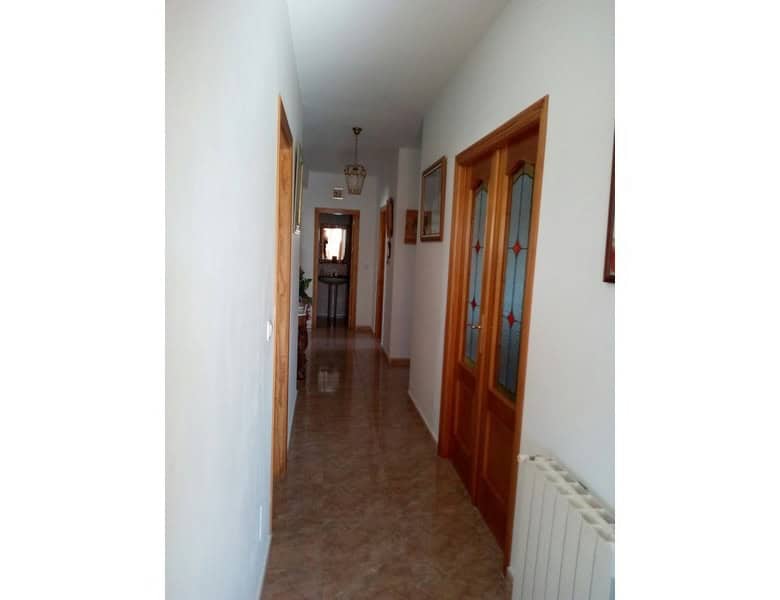 Charming village property in Hijate, Almeria, featuring traditional wooden doors and a cozy hallway.