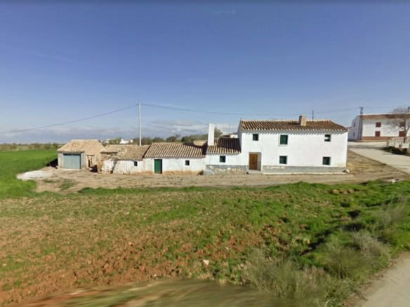 Charming rural property in Baza, Granada, featuring traditional whitewashed buildings and surroundin.