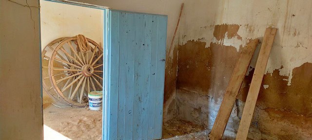 Rural property interior in Baza, Granada, showing rustic construction and storage area.