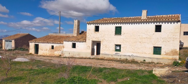 Rural property in Baza, Granada, featuring traditional stone buildings and scenic countryside views.