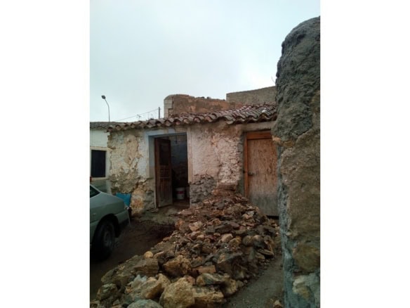Old stone ruin in Oria, Almeria, Spain, with weathered walls and a partially collapsed roof.