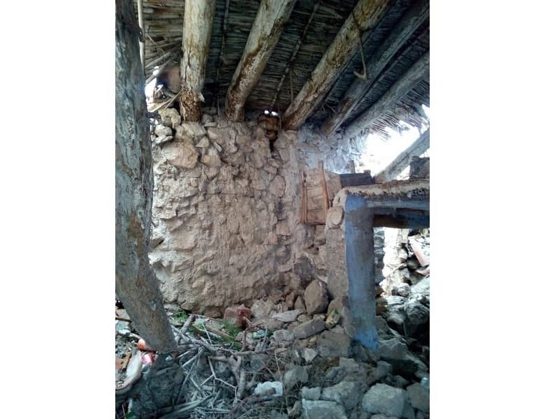 Ancient stone ruin beneath a wooden structure in Oria, Almeria, showcasing historical architecture.