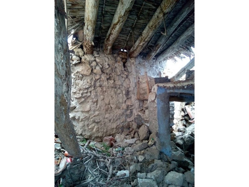 Ancient stone ruin beneath a wooden structure in Oria, Almeria, showcasing historical architecture.