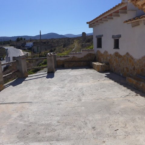 Traditional cave house in Orce, Granada with scenic mountain views.