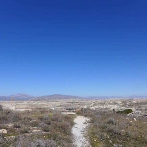 Remote cave house location in Orce, Granada with open landscape and clear blue sky.