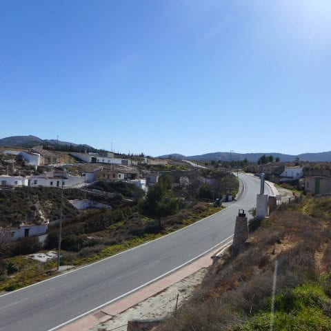 Unique cave house in Orce, Granada, set in a scenic rural landscape with rolling hills and clear blu.
