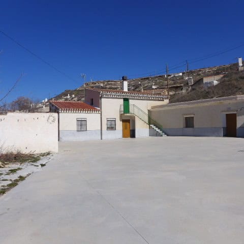 Traditional cave house in Orce, Granada, with whitewashed walls and a terracotta roof.