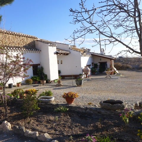 Traditional Cave House in Huescar, Granada with whitewashed walls and rustic charm.