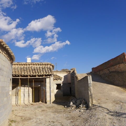 Cave house in Huescar, Granada, showcasing rustic stone walls and unique architecture.