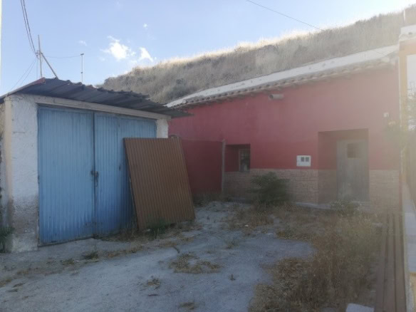 Cave house in Orce, Granada, with rustic exterior and surrounding landscape.