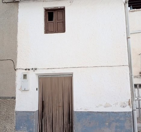 Town house in Gor, Granada with traditional architecture and white exterior walls.