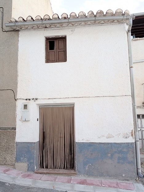 Town house in Gor, Granada with traditional architecture and white exterior walls.
