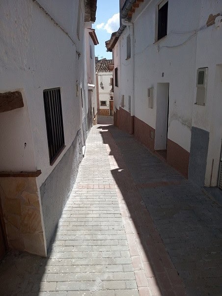 Village street in Gor, Granada with whitewashed walls and narrow pathway.