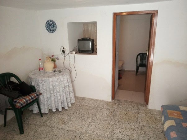 Charming village property in Gor, Granada featuring a cozy living space with simple furnishings and.