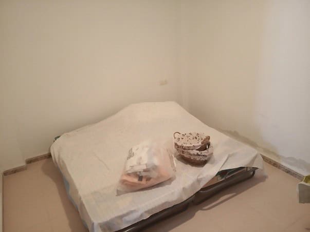 Cozy bedroom in a village property in Gor, Granada, featuring simple furnishings and a clean, minima.