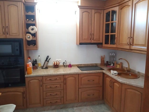 Rural property kitchen in Gor, Granada with wooden cabinets and modern appliances. Perfect for count.