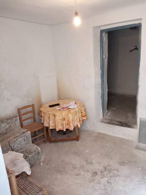 Village property interior with simple furnishings and unfinished walls in Gor, Granada.