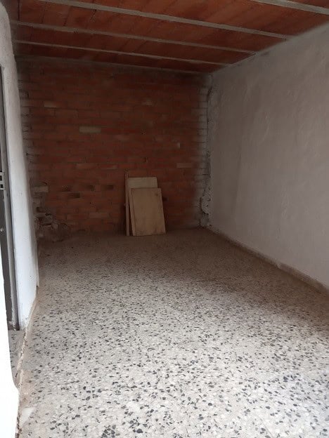 Interior view of a rustic village property in Gor, Granada, showcasing unfinished walls and flooring.