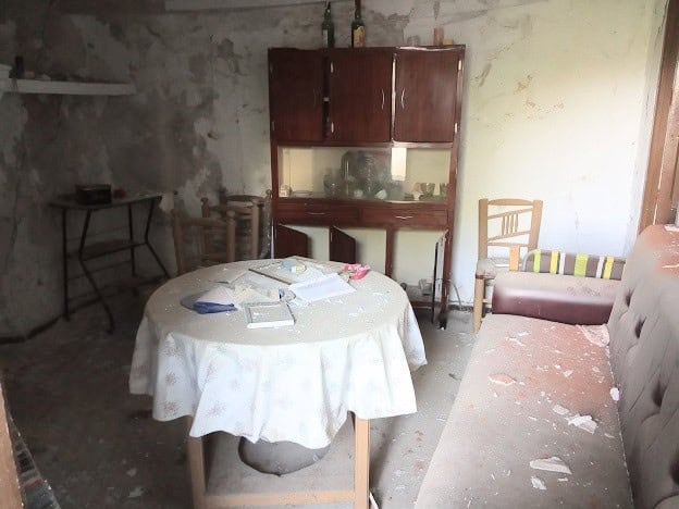 Charming interior of a rural property in Belerda, Jaen, featuring rustic furniture and a simple livi.