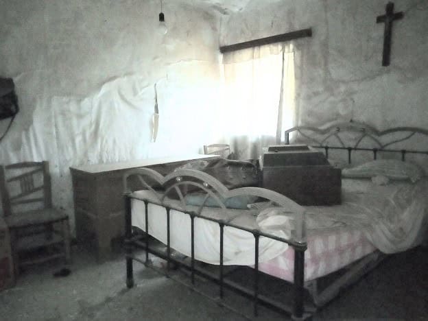 Charming rustic bedroom in Belerda, Jaen with vintage furniture and simple decor.