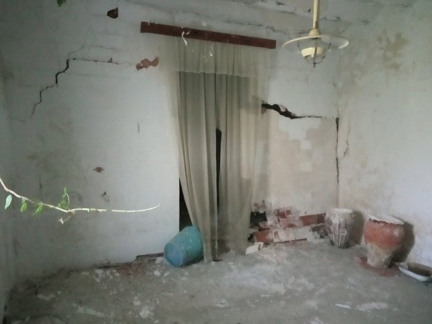 Old rural property interior with damaged walls and rustic charm in Belerda, Jaen.