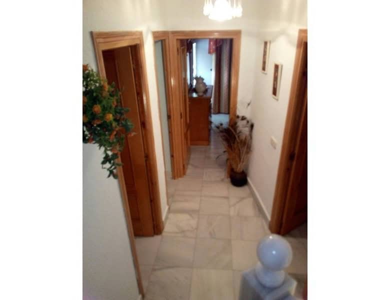 Cozy hallway of a village property in Somontin, Almeria, featuring wooden door frames and decorative.