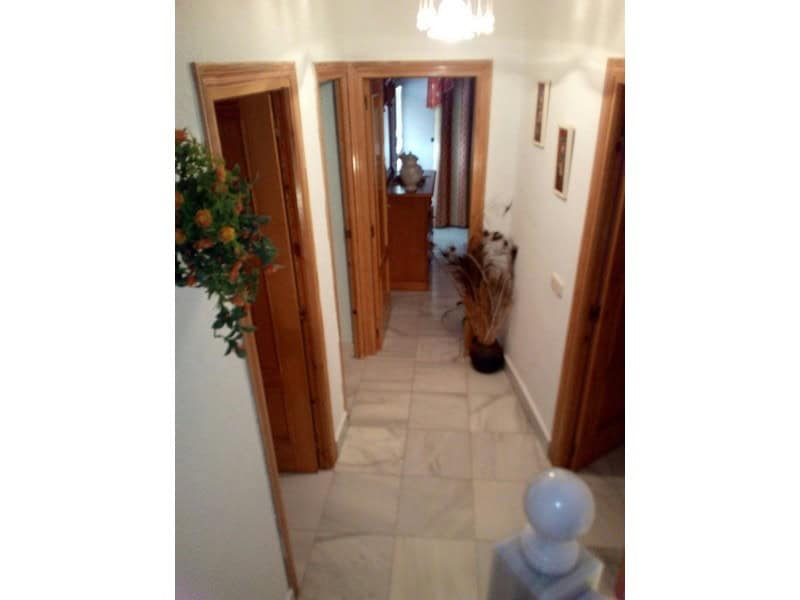 Cozy hallway of a village property in Somontin, Almeria, featuring wooden door frames and decorative.