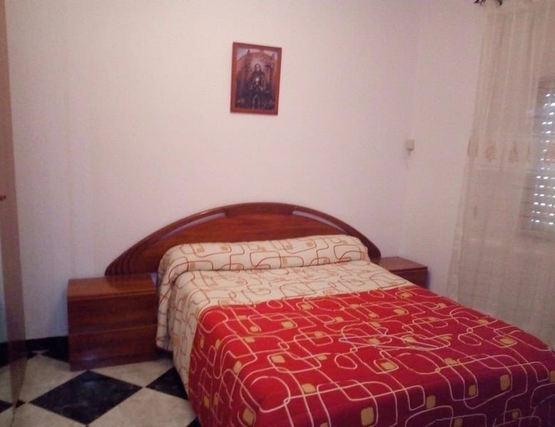 Cozy bedroom in a village property in Somontin, Almeria, featuring traditional decor and natural lig.
