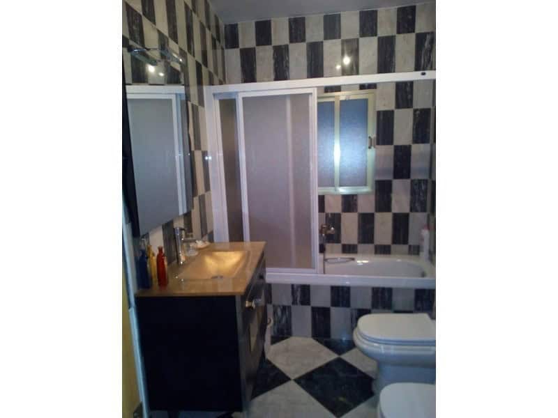 Modern bathroom in a village property in Somontin, Almeria with stylish black and white tiles.