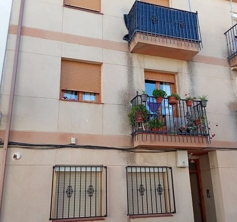 Apartment in Gor, Granada featuring a balcony with potted plants and closed window shutters.