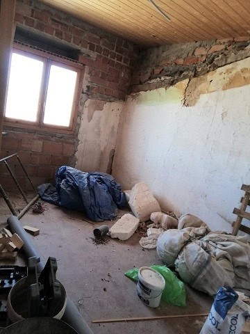 Charming village property renovation site in Gor, Granada with exposed brick walls and construction.