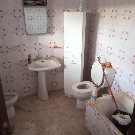 Village Property Bathroom in Gor, Granada with basic fixtures and rustic charm.