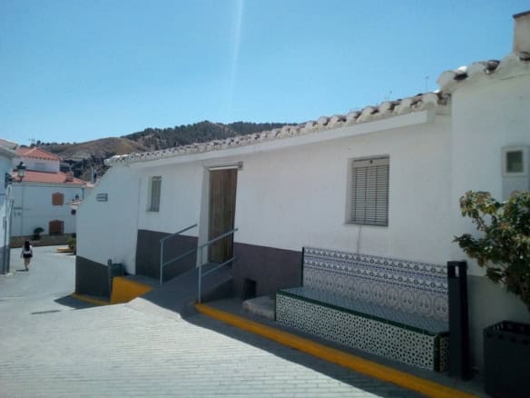 Charming village property in Armuna, Almeria with accessible entrance and traditional tiled exterior.