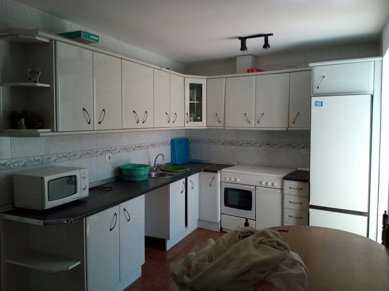 Charming village property in Armuna, Almeria, featuring a modern kitchen with white cabinets and ess.